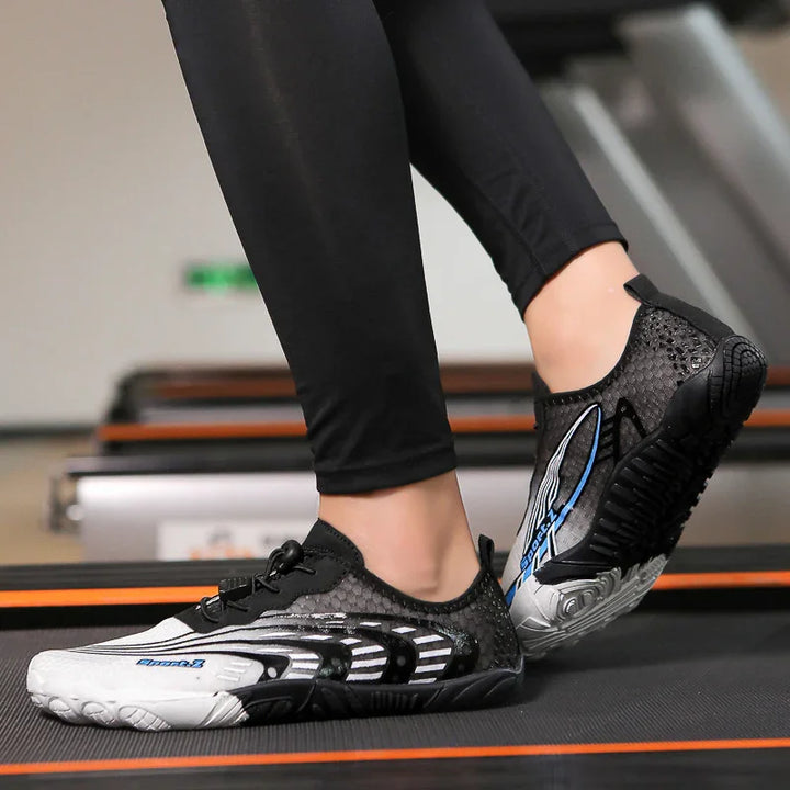 Person wearing black and white minimalist running shoes on treadmill, stylish fitness footwear