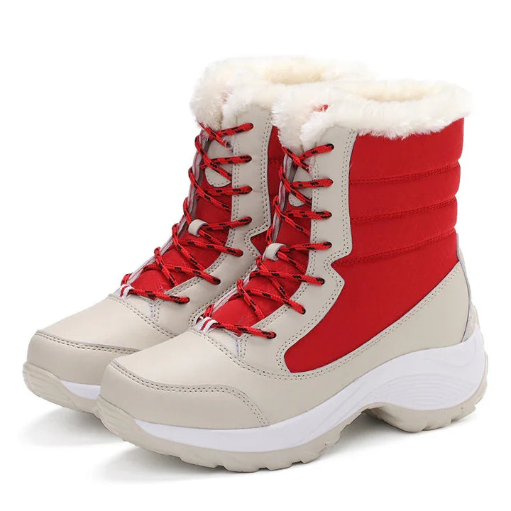 Red and beige winter boots with fur lining and lace-up front on white background