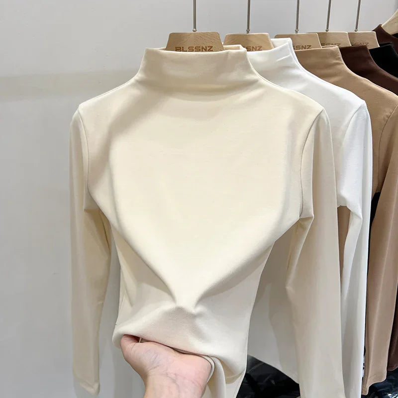Soft cotton long sleeve turtleneck tops in cream, white, beige, and brown on hangers