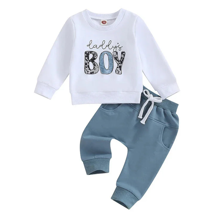 White toddler sweatshirt with 'Daddy's Boy' text and blue toddler pants with drawstring