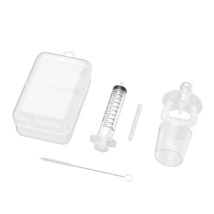 Clear plastic syringe feeding kit with measuring cup, cleaning brush, and storage case