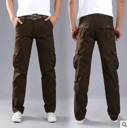 Brown men's cargo pants with multiple pockets worn with white sneakers and a white t-shirt