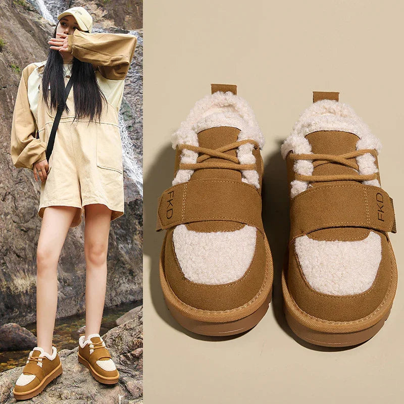 Woman wearing beige shearling sneakers and oversized beige outfit, with close-up of brown and white shearling shoes