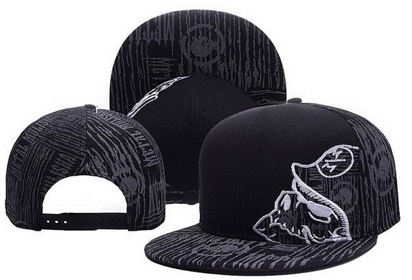 Black snapback caps with monochrome skull and abstract pattern embroidery, displayed in three angles