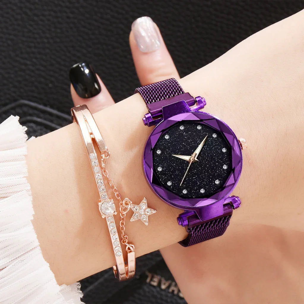 Purple mesh strap wristwatch with black glitter dial and gold hands worn with rose gold crystal bracelet