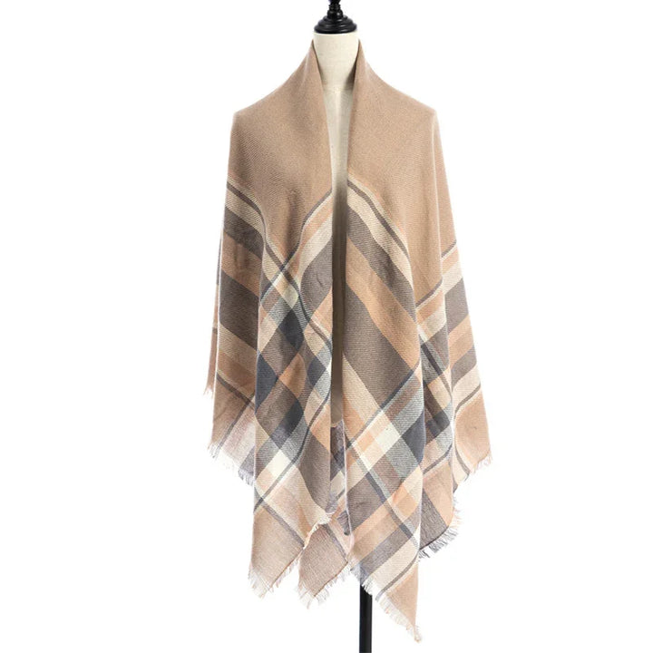 Beige plaid shawl with fringe edges displayed on a dress form mannequin