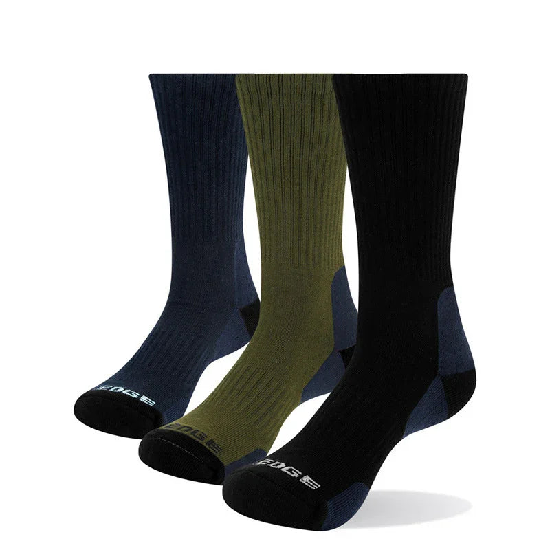 Three pairs of ribbed crew socks in navy, olive green, and black with reinforced heels and toes