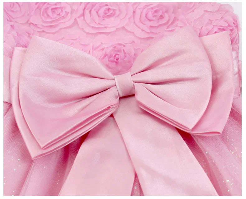 Close-up of a pink satin bow on a textured floral pink fabric background