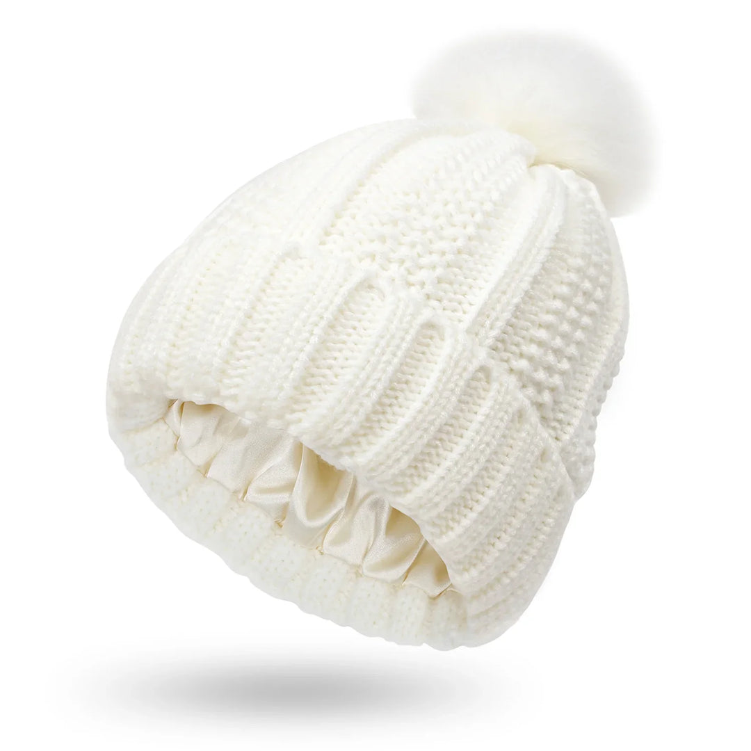 White knitted winter beanie with a fluffy pom pom and satin-lined interior