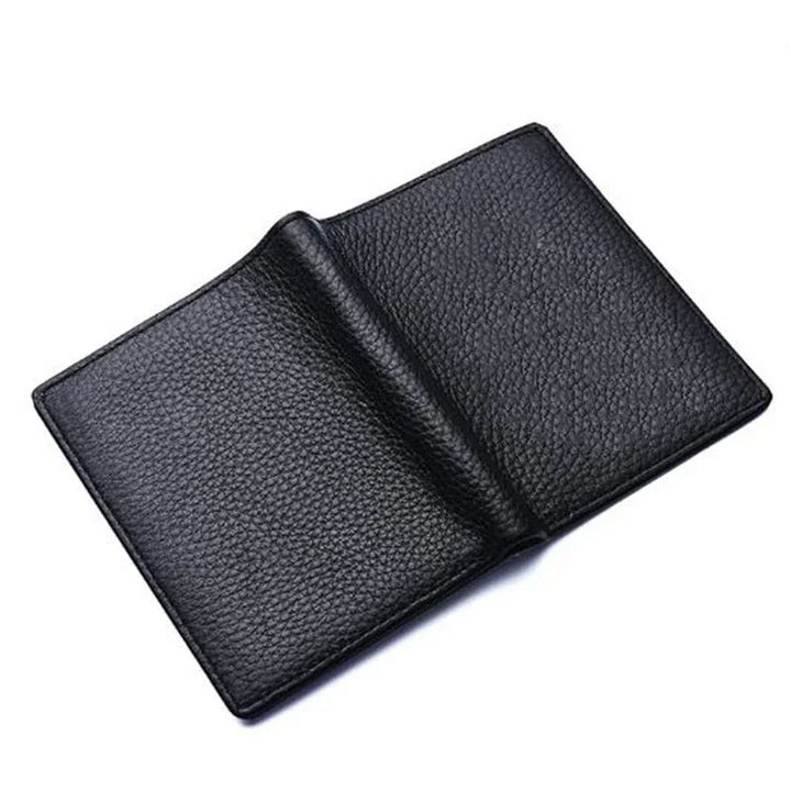 Open black pebbled leather wallet on white background with visible texture