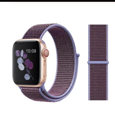 Gold smartwatch with purple woven nylon loop band and floral watch face design