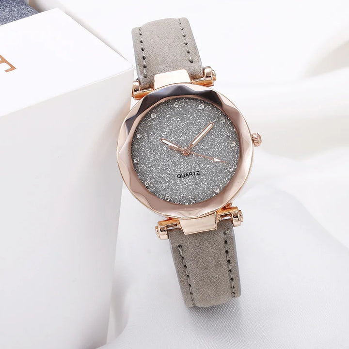 Elegant women's quartz watch with glittery silver dial, rose gold case, and grey suede strap