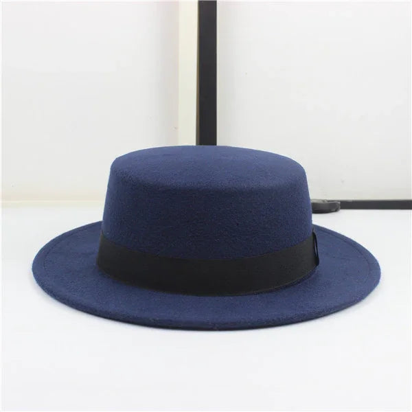 Navy blue fedora hat with black band against a plain white background