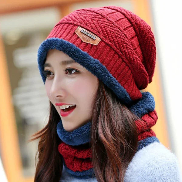 Young woman wearing a cozy red knit hat and matching scarf with blue fleece lining