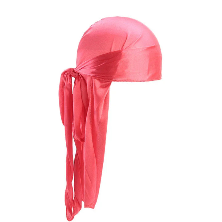 Silky coral pink durag with long tail ties on white background