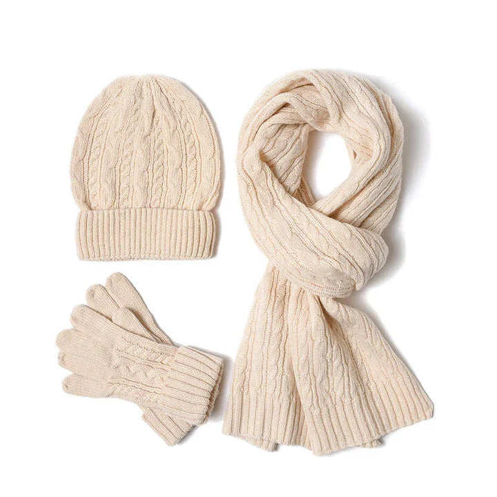 Cream cable knit winter hat, scarf, and gloves set on white background