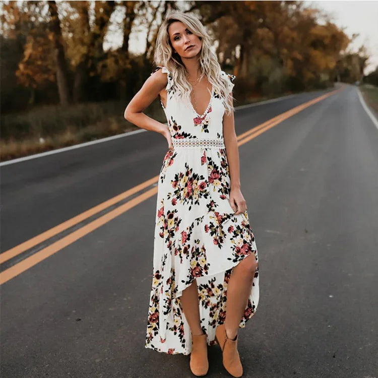 Woman in white floral dress with high-low hem standing on empty road in autumn setting