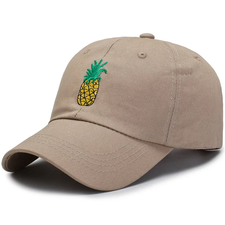 Beige baseball cap with embroidered yellow pineapple and green leaves design