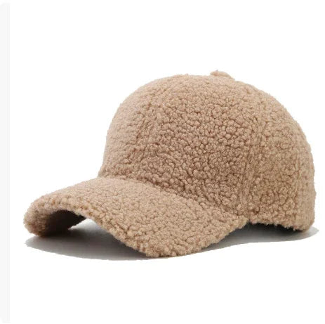 Beige fuzzy sherpa fabric baseball cap with curved brim on white background