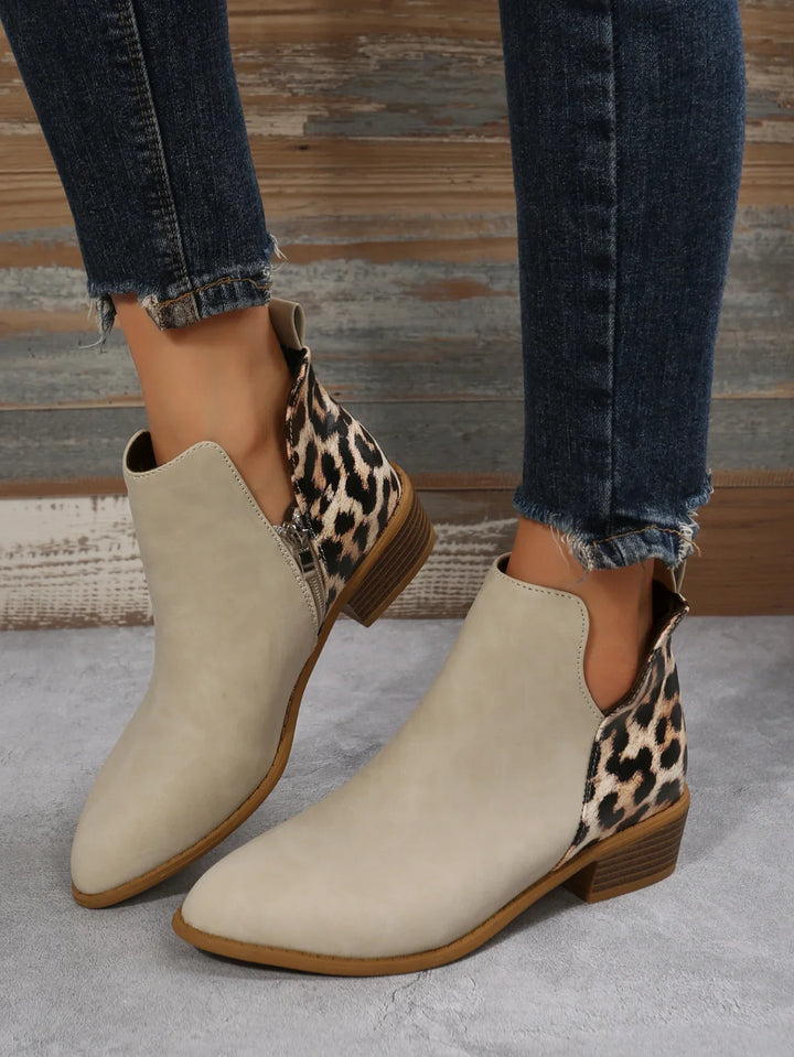 Beige ankle boots with leopard print heel detail and zipper worn with frayed blue jeans