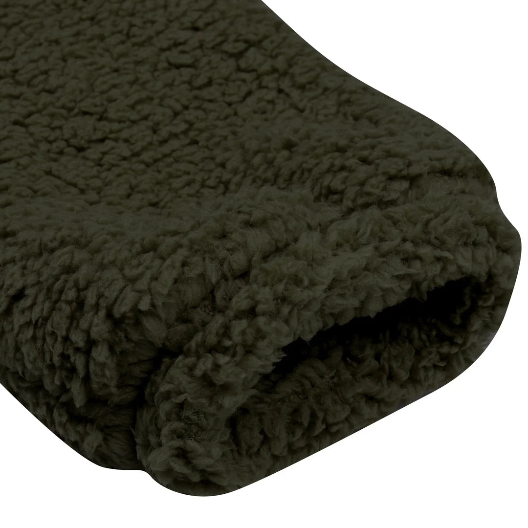 Close-up of folded dark olive green fleece blanket with soft, textured fabric