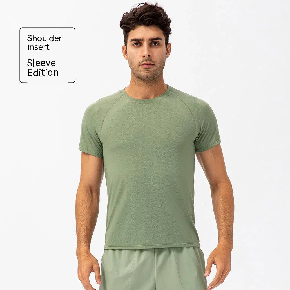 Man wearing light green shoulder insert sleeve edition athletic t-shirt and shorts