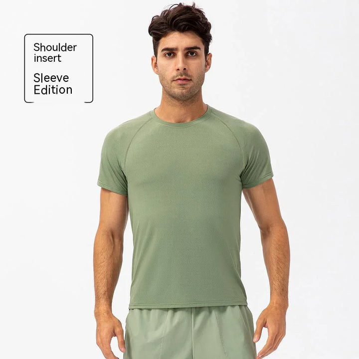 Man wearing light green shoulder insert sleeve edition athletic t-shirt and shorts