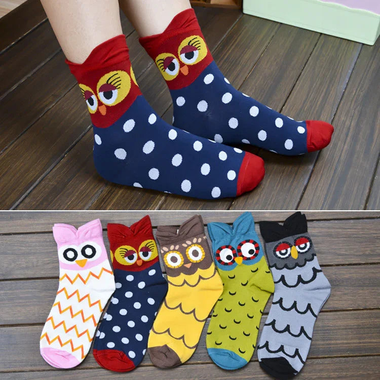 Colorful owl-themed socks with polka dots and zigzag patterns on wooden floor