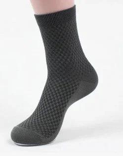 Black textured ankle sock on white background, showcasing woven pattern and fitted shape