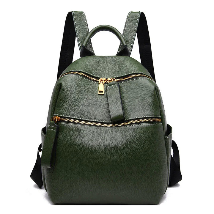 Green textured leather backpack with gold zippers and black adjustable shoulder straps