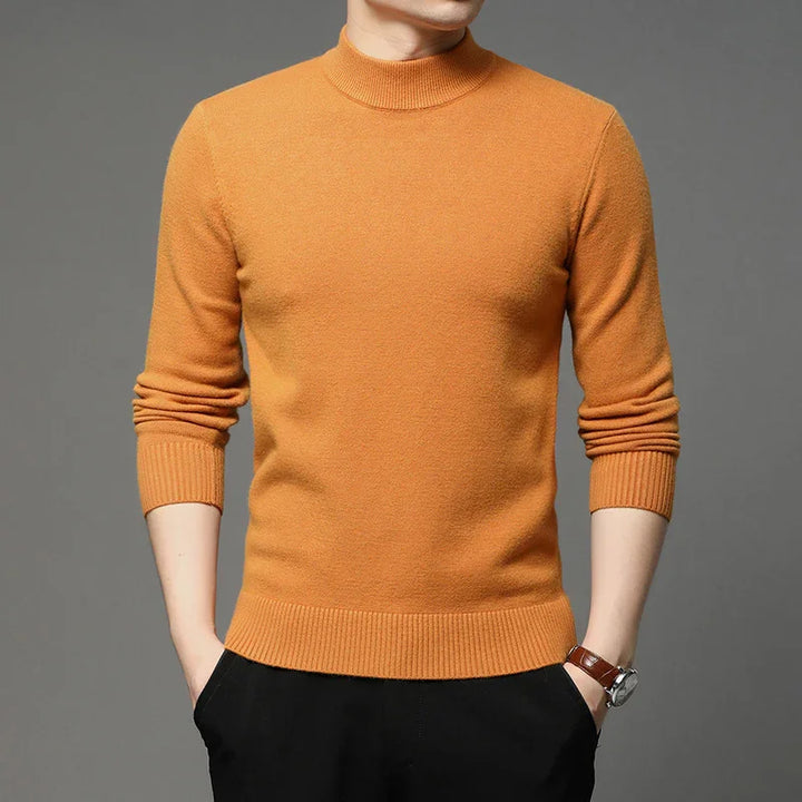 man wearing mustard yellow turtleneck sweater with long sleeves and black pants