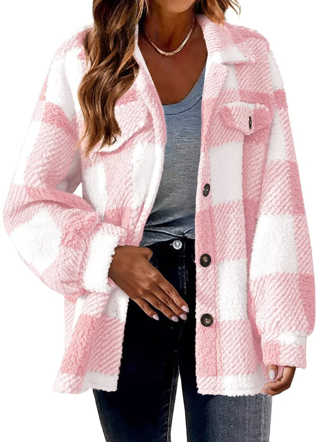 Woman wearing pink and white sherpa plaid button-up jacket with black jeans and gray shirt