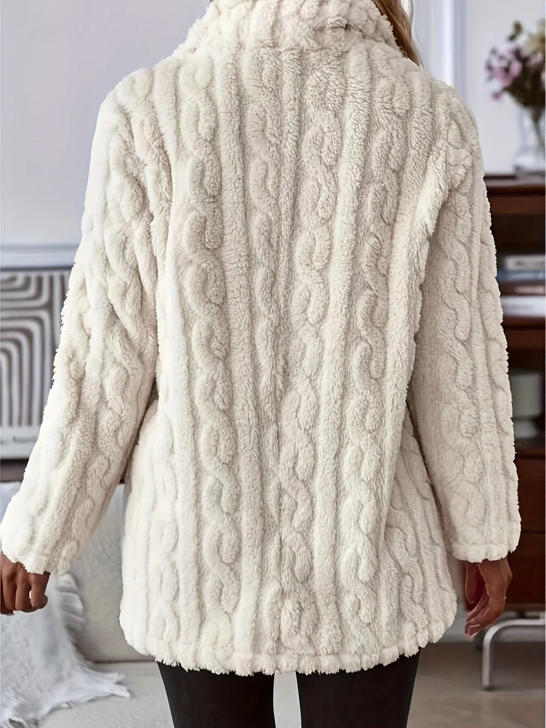 Back view of person wearing cozy white cable knit textured fleece jacket indoors