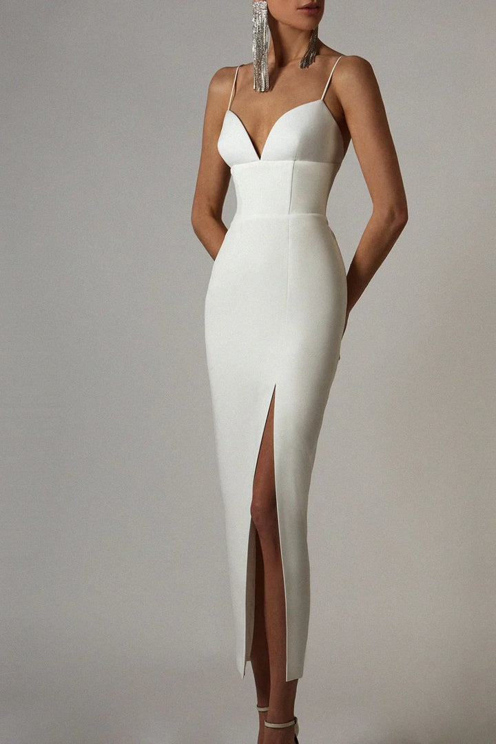 Elegant white sleeveless midi dress with thigh slit and deep neckline on model