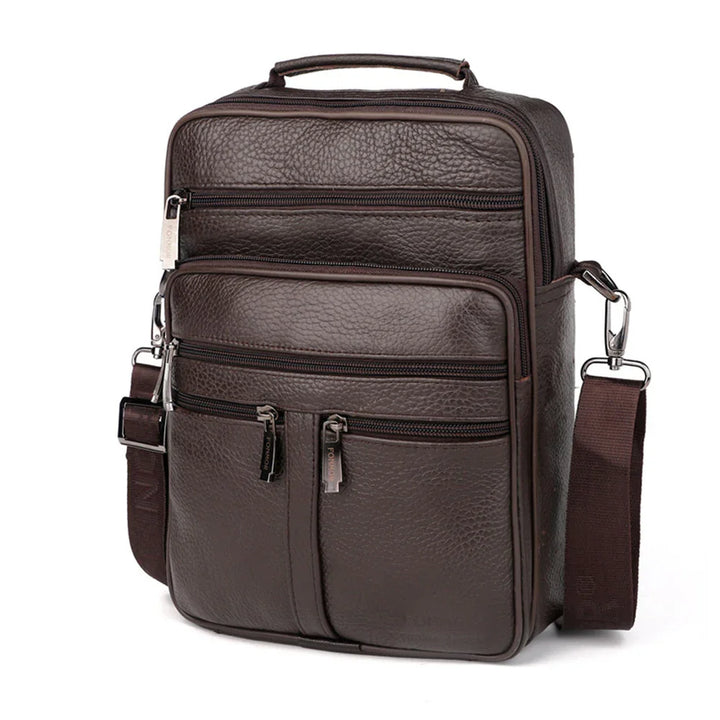 Dark brown textured leather crossbody bag with multiple zippered pockets and adjustable strap