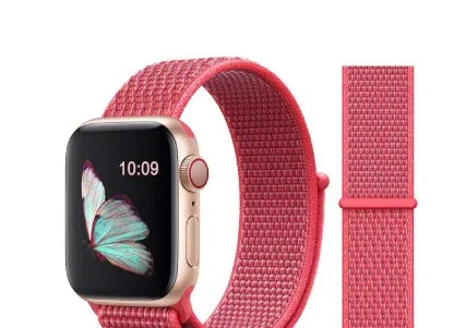 Smartwatch with a rose gold aluminum case and pink woven nylon band featuring butterfly wallpaper