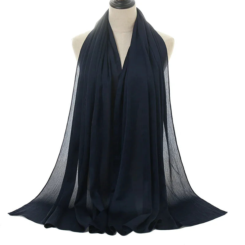 Elegant black chiffon scarf displayed on a mannequin with flowing draped fabric