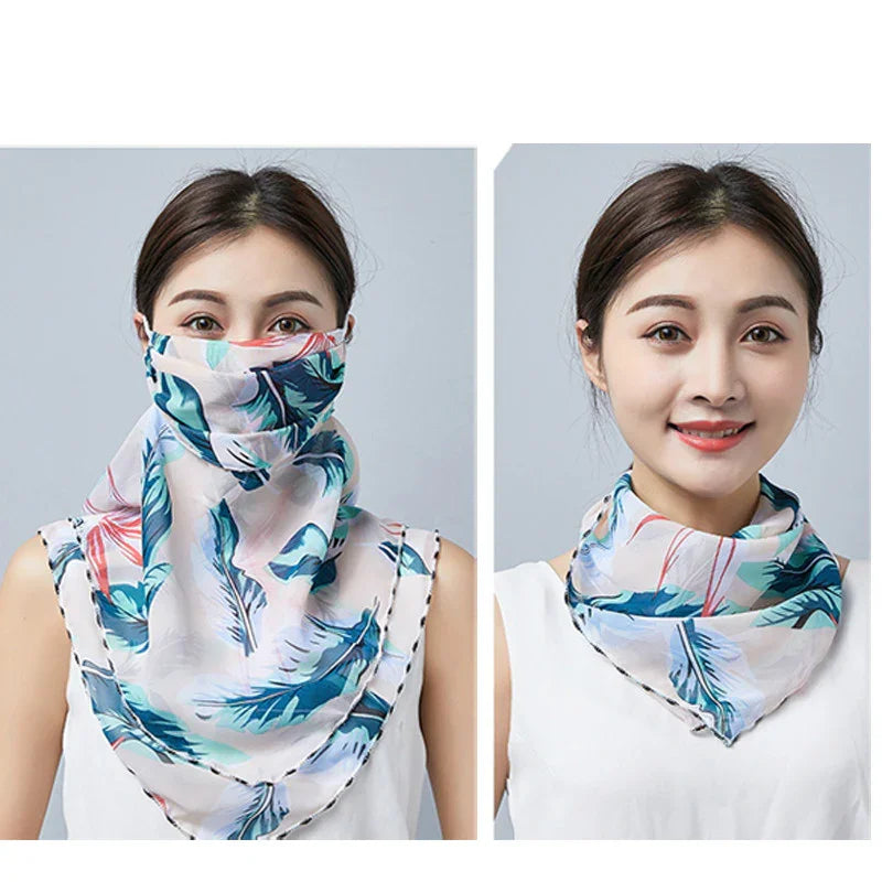 Woman wearing a colorful feather print scarf styled as face cover and neck accessory