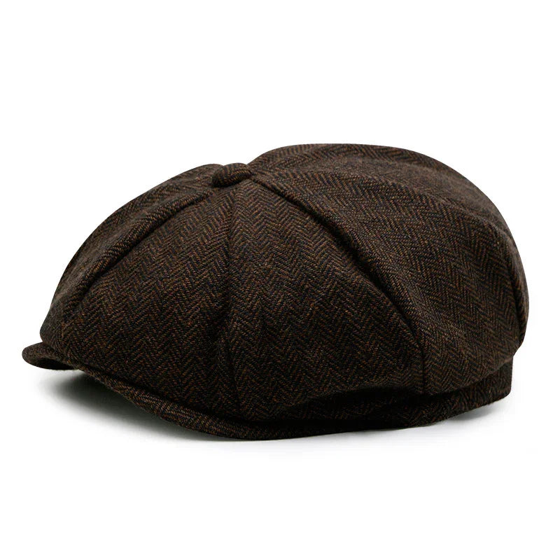 Brown herringbone patterned newsboy cap with button top on a white background