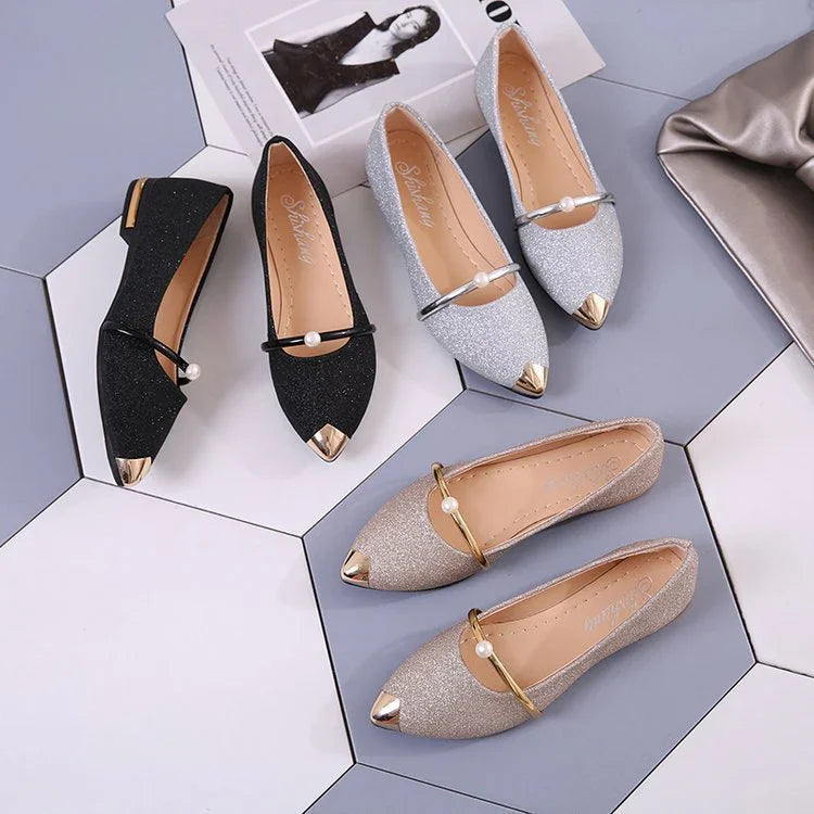 Elegant women's glitter pointed flats in black, silver, and gold with pearl-accented straps on hexagonal tiles