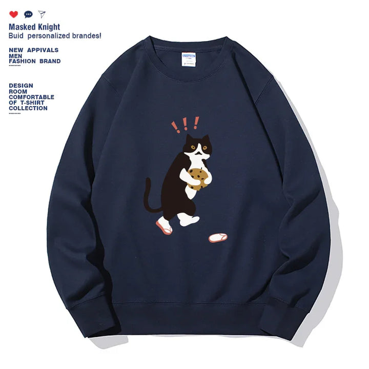 Navy blue sweatshirt with graphic of surprised black and white cat holding cookie with slippers nearby