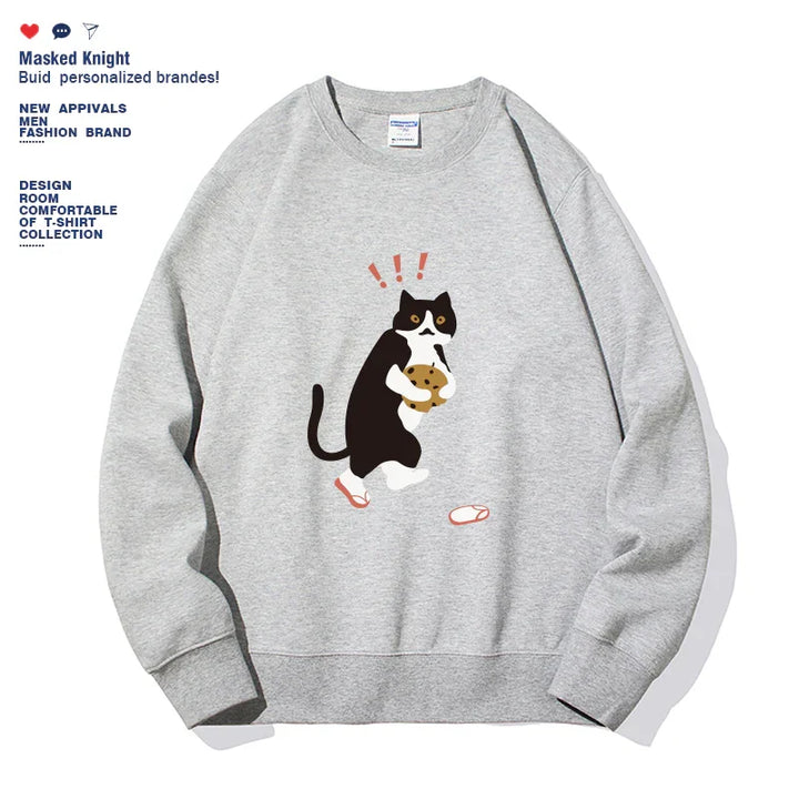Gray sweatshirt featuring a black and white cat holding a cookie with surprised expression and fallen slippers