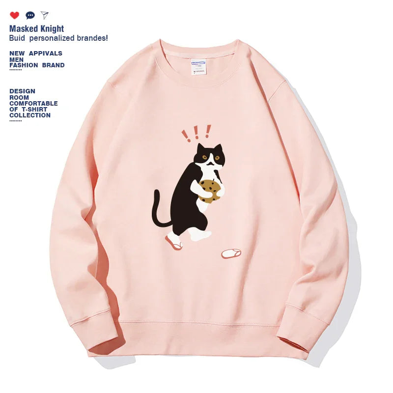 Light pink sweatshirt with a surprised black and white cat holding a cookie graphic and fallen slippers