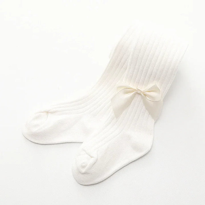 White ribbed baby tights with a small bow detail on a white background