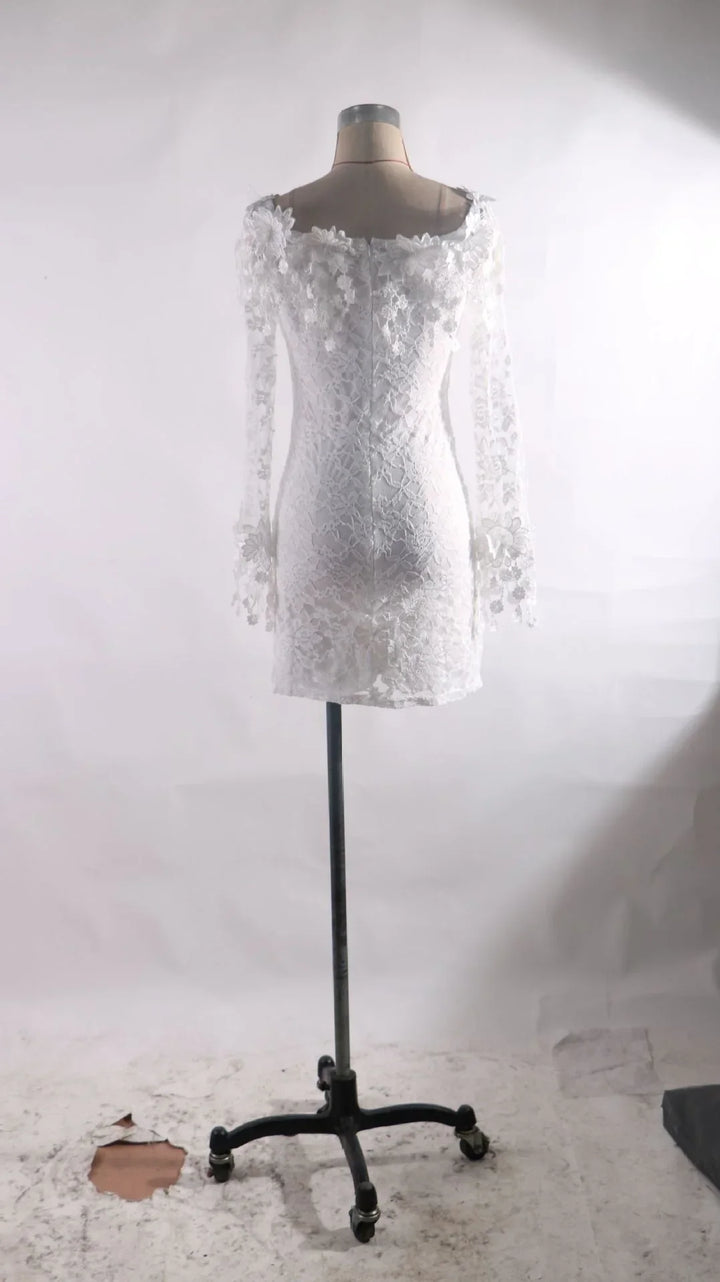 Back view of white lace long-sleeve mini dress on mannequin with floral detailing