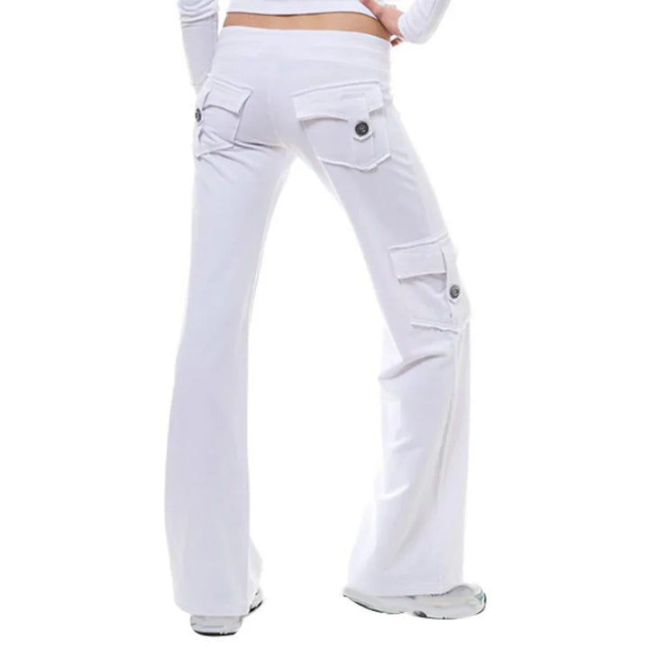 Back view of white cargo pants with buttoned pockets on model wearing white shoes