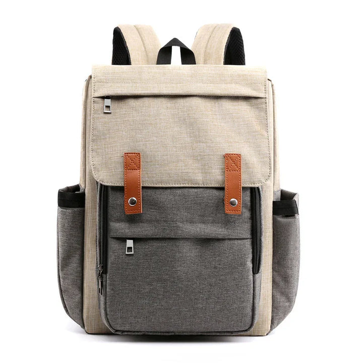Two-tone beige and gray fabric backpack with brown leather straps and multiple zippered pockets