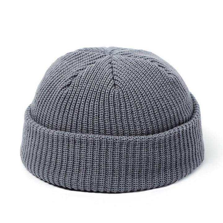 Gray knitted beanie hat with folded cuff on white background