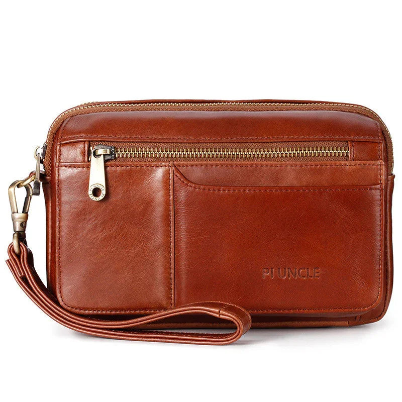Brown leather wristlet wallet with front zipper pocket and embossed PU UNCLE logo