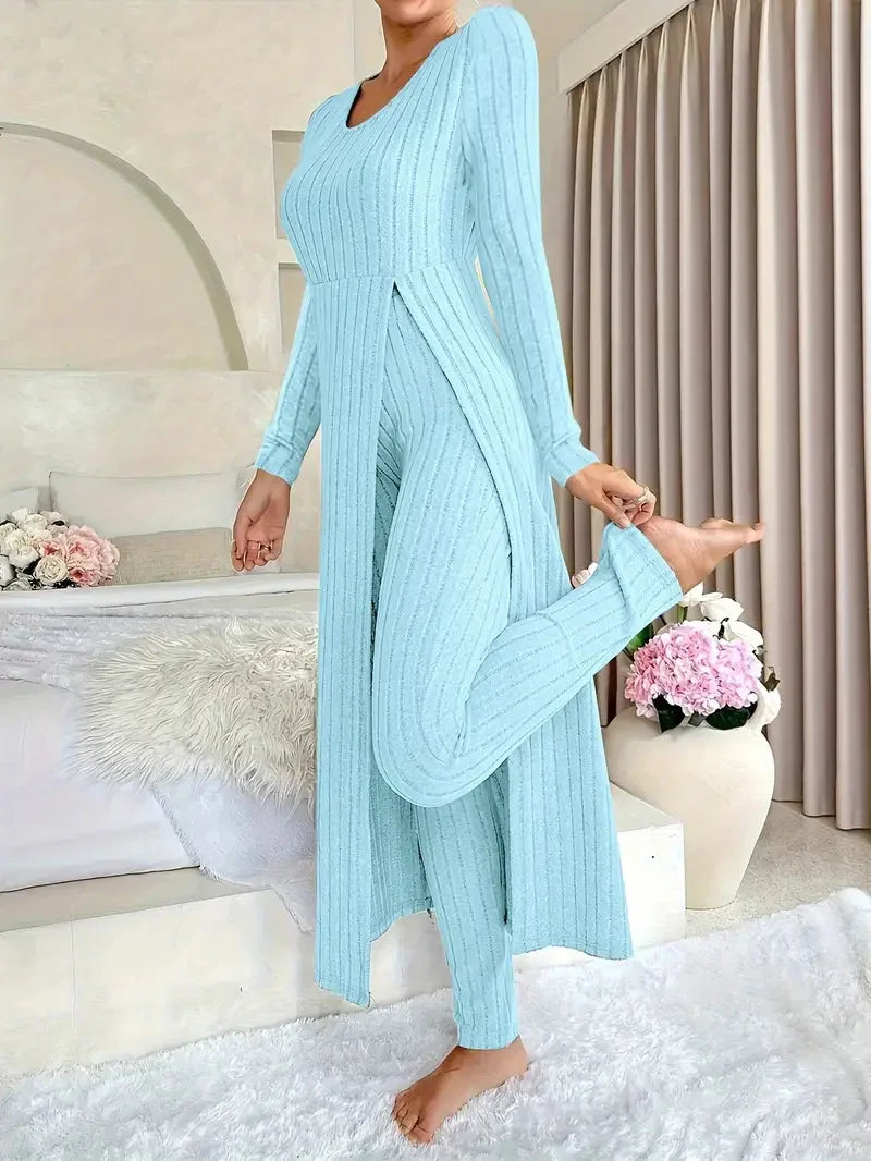 Woman in light blue ribbed knit loungewear set standing barefoot in cozy modern bedroom